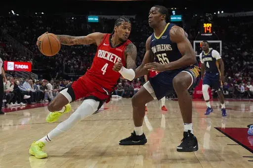 Houston Rockets guard Jalen Green (4) controls the ball against New Orleans Pelicans center Trey Jemison III (55) during the first half of an NBA basketball game in Houston, Thursday, Dec. 19, 2024. (AP Photo/Ashley Landis)
