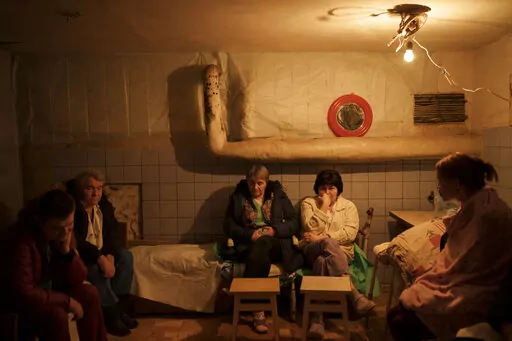 Hospital staff sit in a basement, used as a bomb shelter, during an air raid alarm in Brovary, north of Kyiv, Ukraine, Thursday, March 17, 2022. (AP Photo/Felipe Dana)