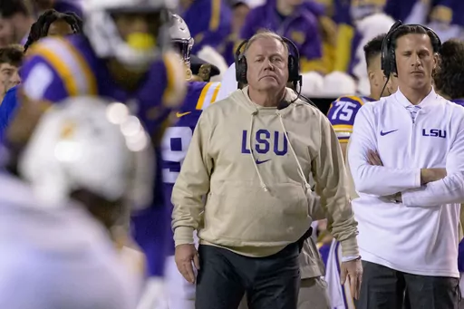 LSU head coach Brian Kelly, center, watches from the sideline during the second half of an NCAA college football game against Georgia State in Baton Rouge, La., Saturday, Nov. 18, 2023. (AP Photo/Matthew Hinton, File)