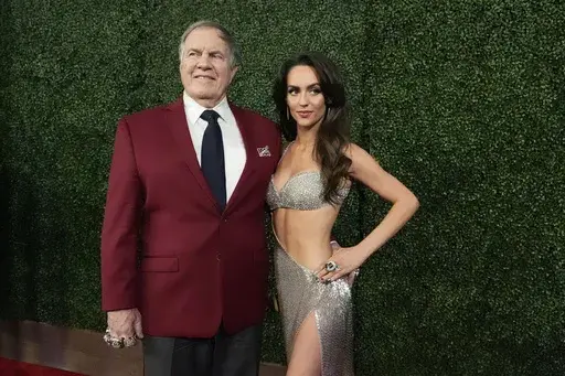 Former NFL head coach Bill Belichick and girlfriend Jordon Hudson, pose on the red carpet at the NFL Honors award show ahead of the Super Bowl 59 football game, Thursday, Feb. 6, 2025, in New Orleans. (AP Photo/Brynn Anderson)