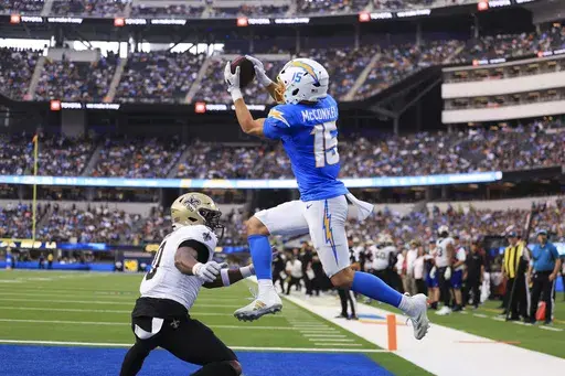 Los Angeles Chargers wide receiver Ladd McConkey (15) pulls in a touchdown reception over New Orleans Saints safety Ugo Amadi (0) in the second half of an NFL football game in Inglewood, Calif., Sunday, Oct. 27, 2024. (AP Photo/Ryan Sun)