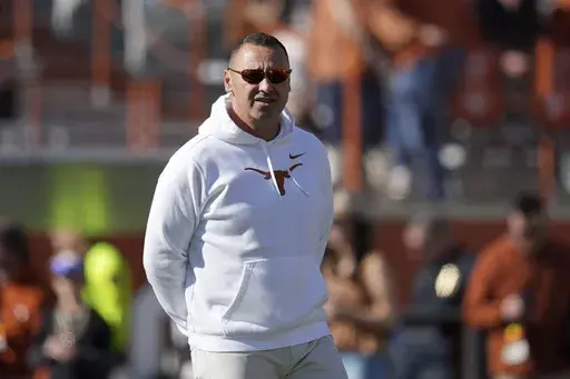 Texas head coach Steve Sarkisian watches his team warmup before a first round game of the College Football Playoff against Clemson, Saturday, Dec. 21, 2024, in Austin, Texas. (AP Photo/Eric Gay)