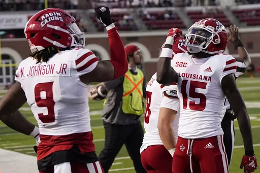 Louisiana-Lafayette tight end Neal Johnson (9) clebrates his touchdown with Robert Williams (15) during the second half of an NCAA college football game against Troy, Saturday, Nov. 18, 2023, in Troy, Ala. (AP Photo/Mike Stewart)