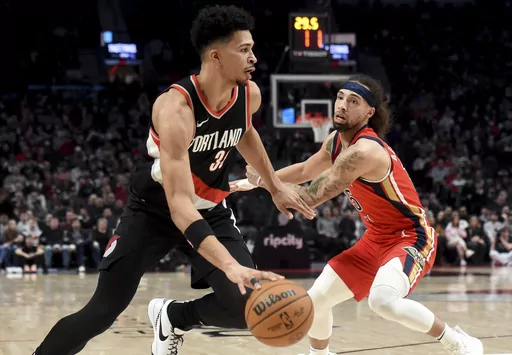 Portland Trail Blazers forward Toumani Camara, left, drives against New Orleans Pelicans guard Jose Alvarado during the first half of an NBA basketball game in Portland, Ore., Saturday Feb. 10, 2024. (AP Photo/Steve Dykes)