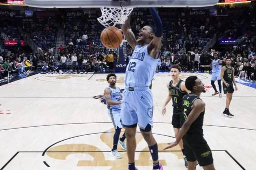 Memphis Grizzlies guard Ja Morant slam dunks in the final seconds of overtime during an NBA basketball game against the New Orleans Pelicans in New Orleans, Tuesday, Dec. 26, 2023. The Grizzlies won 116-115. (AP Photo/Gerald Herbert)