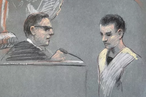 This artist depiction shows Massachusetts Air National Guardsman Jack Teixeira, right, appearing in U.S. District Court in Boston, April 14, 2023. The massive classified documents leak by an Air Force service member earlier this year was made worse by the intentional failure by multiple officials to report to take required action on his suspicious behavior, the Air Force inspector general reported Monday. Massachusetts Air National Guard member Jack Teixeira is accused of leaking highly classifi