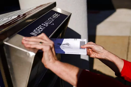 A person drops off a mail-in ballot at an election ballot return box in Willow Grove, Pa., Oct. 25, 2021. On Tuesday, May 3, 2022, The Associated Press reported on a film that used a flawed analysis of cellphone location data and ballot drop box surveillance footage to cast doubt on the results of the 2020 presidential election. (AP Photo/Matt Rourke)