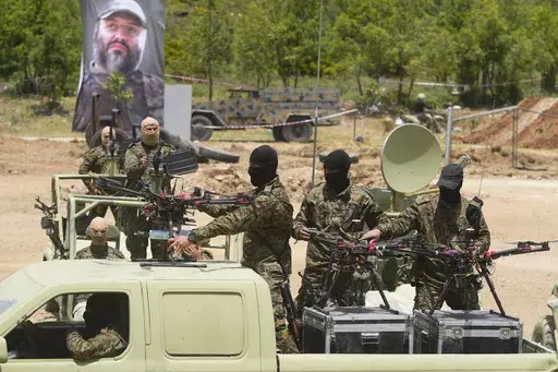 Hezbollah militants take part in a military exercise with armed drones in Aaramta village in the Jezzine District, southern Lebanon, on May 21, 2023. (AP Photo/Hassan Ammar, File)
