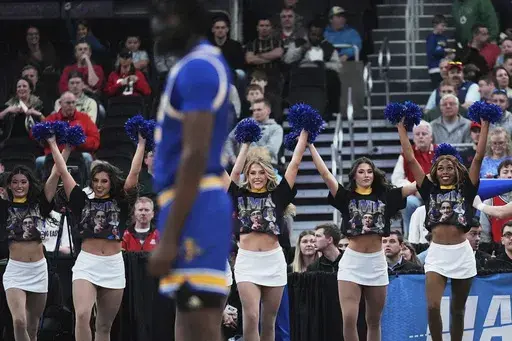 McNeese State cheerleaders wear t-shirts highlighting team student manager Amir Kahn during the first half in the second round of the NCAA college basketball tournament, Saturday, March 22, 2025, in Providence, R.I. (AP Photo/Charles Krupa)