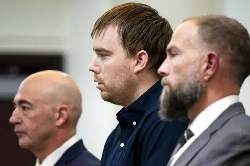 Travis Reinking, center, reacts as the verdict is read during day five of Reinking's murder trial at the Justice A.A. Birch Building in Nashville, Tenn., Friday, Feb. 4, 2022. A jury found Reinking guilty of first-degree murder in the deaths of four people at a Waffle House in 2018. (Andrew Nelles/The Tennessean via AP, Pool)