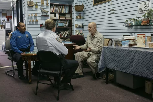 Police talks to Zein Ramawi, right, leader of the Islamic Society of Bay Ridge mosque, at An-Noor Social Center on Friday, Oct. 13, 2023, in the Brooklyn borough of New York. In Muslim communities across the world, worshippers gathered at mosques for their first Friday prayers since Hamas militants attacked Israel, igniting the latest Israel-Palestinian war. (AP Photo/Andres Kudacki)