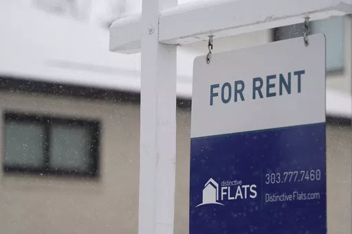 A for rent sign stands outside a single-family home on the market Saturday, Feb. 10, 2024, in Denver. A record number of Americans who rent are now considered cost-burdened, with 30% or more of their income going toward rent and utilities. Companies like Flex, which let you divide your rent into smaller installments via a line of credit or loan, say they’re part of the solution. (AP Photo/David Zalubowski, File)