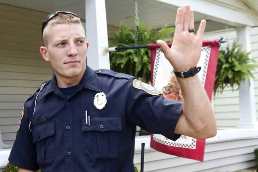 Grand Rapids Police Officer Christopher Schurr stops to talk with a resident, on Aug. 12, 2015, in Grand Rapids, Mich. Schurr, charged with second-degree murder in the death of Patrick Lyoya, a Black man who was shot in the back of the head in April, has been fired, officials said Wednesday, June 15, 2022. (Emily Rose Bennett/The Grand Rapids Press via AP, File)