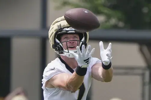 New Orleans Saints quarterback Taysom Hill runs through drills during an NFL football practice in Metairie, La., Tuesday, May 28, 2024. (AP Photo/Gerald Herbert)