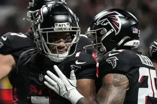 Atlanta Falcons running back Bijan Robinson (7) celebrates his touchdown against the Kansas City Chiefs during the first half of an NFL football game, Sunday, Sept. 22, 2024, in Atlanta. (AP Photo/Brynn Anderson)