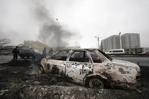 A car, which was burned after clashes, is seen on a street in Almaty, Kazakhstan, Friday, Jan. 7, 2022. Kazakhstan's president authorized security forces on Friday to shoot to kill those participating in unrest, opening the door for a dramatic escalation in a crackdown on anti-government protests that have turned violent. The Central Asian nation this week experienced its worst street protests since gaining independence from the Soviet Union three decades ago, and dozens have been killed in the 