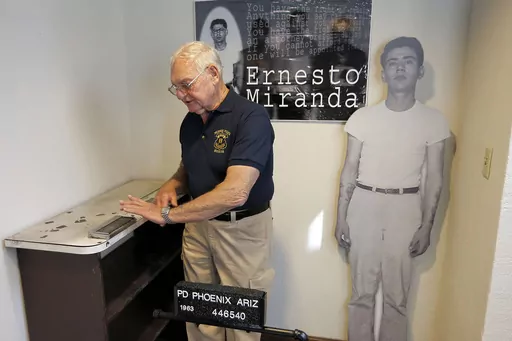 Retired Phoenix Police Capt. Carroll Cooley demonstrates Wednesday, March 13, 2013, at the Phoenix Police Museum in Phoenix, how Ernesto Miranda was fingerprinted on the same fingerprinting device used on Miranda. Cooley, the arresting officer in the landmark self-incrimination case that led in part to the Supreme Court's Miranda rights ruling requiring officers to read suspects their rights, died on Monday, May 29, after an unspecified illness, the department confirmed Friday, June 2, 2023. He 