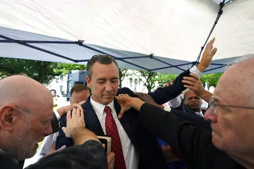 Tony Spell, pastor of the Life Tabernacle Church of Central City, La., prays with supporters outside the Fifth Circuit Court of Appeals in New Orleans on June 7, 2021.  An outspoken Christian conservative attorney from Alabama has asked a federal appeals court to revive the Louisiana pastor’s damage claims against state officials over long-expired COVID-19 restrictions.  A federal judge had earlier this year dismissed minister Spell’s lawsuit against Gov. John Bel Edwards and others over enf