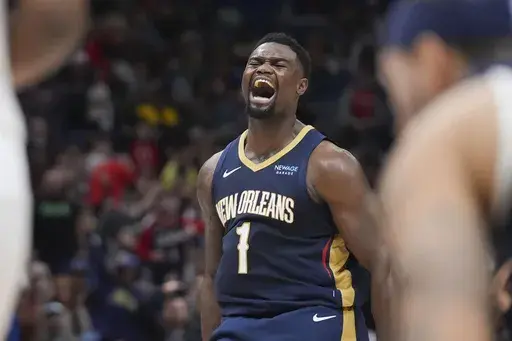 New Orleans Pelicans forward Zion Williamson (1) reacts after his alley-oop slam dunk in the second half of an NBA basketball game against the Utah Jazz in New Orleans, Friday, Jan. 17, 2025. (AP Photo/Gerald Herbert)