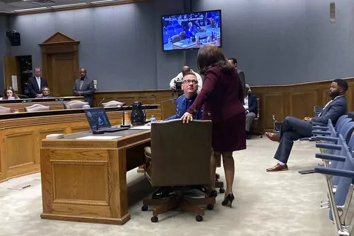 Louisiana State Police Lt. Col. Doug Cain, the agency’s second in command, confers with Gail Holland, a Louisiana State Police attorney,  while testifying Tuesday, March 22, 2022,  in Baton Rouge, La., before a legislative panel conducting an "all-levels" probe into the fatal 2019 arrest of Black motorist Ronald Greene. (AP Photo/Jim Mustian)