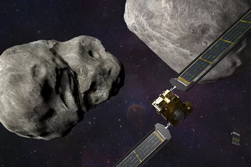 This illustration made available by Johns Hopkins APL and NASA depicts NASA's DART probe, foreground right, and Italian Space Agency's (ASI) LICIACube, bottom right, at the Didymos system before impact with the asteroid Dimorphos, left. DART is expected to zero in on the asteroid Monday, Sept. 26, 2022, intent on slamming it head-on at 14,000 mph. The impact should be just enough to nudge the asteroid into a slightly tighter orbit around its companion space rock. (Steve Gribben/Johns Hopkins APL