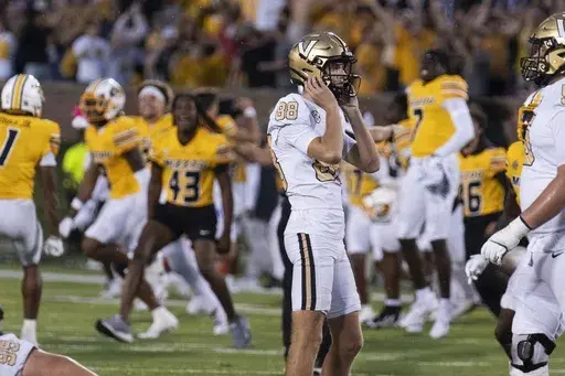 Missouri celebrates behind Vanderbilt place kicker Brock Taylor (88) after he missed a field goal during overtime of an NCAA college football game as Missouri celebrates Saturday, Sept. 21, 2024, in Columbia, Mo. (AP Photo/L.G. Patterson)