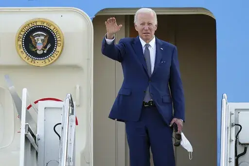 U.S. President Joe Biden waves as he boards Air Force One at Yokota Air Base in Fussa, Japan, Tuesday, May 24, 2022. (AP Photo/Eugene Hoshiko)