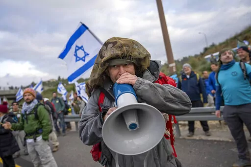 Israeli military reservists protest against the plans by Prime Minister Benjamin Netanyahu's new government to overhaul the judicial system, on a freeway from Tel Aviv to Jerusalem, Thursday, Feb. 9, 2023. A contentious judicial overhaul that is dividing Israel is tearing at the country's main unifying force: the military. Former top security officials are greenlighting insubordination in the face of what they say is impending regime change. And some reservists say they'll heed the call. (AP Pho