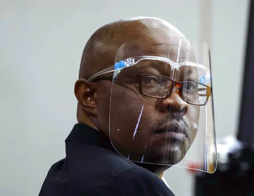 Accused serial killer Billy Chemirmir looks back ahead of his retrial on Monday, April 25, 2022, at Frank Crowley Courts Building in Dallas. The retrial of Chemirmir, charged with killing 18 older women in the Dallas area over a two-year span, began Monday, after the first jury to hear a case against him deadlocked last fall. (Shafkat Anowar/The Dallas Morning News via AP, Pool)