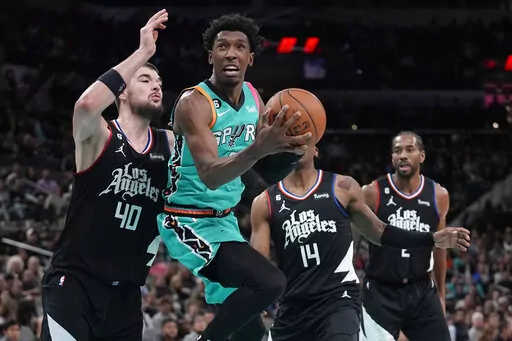 San Antonio Spurs guard Josh Richardson (7) drives to the basket past Los Angeles Clippers center Ivica Zubac (40) during the first half of an NBA basketball game in San Antonio, Friday, Jan. 20, 2023. (AP Photo/Eric Gay)