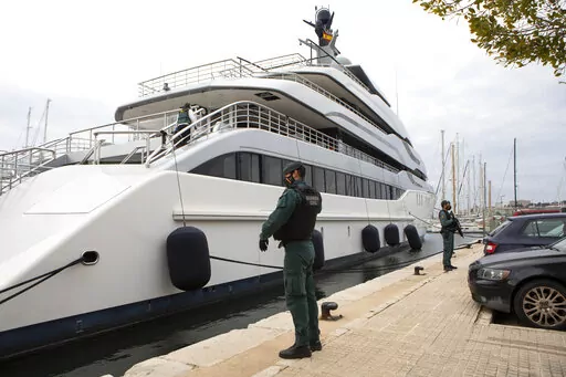 Civil Guards stand by the yacht called Tango in Palma de Mallorca, Spain, Monday April 4, 2022. U.S. federal agents and Spain's Civil Guard are searching the yacht owned by a Russian oligarch.  The United States and allies are again escalating sanctions against Russia, Wednesday, April 6, after evidence that Russian troops murdered Ukrainian civilians in a town near Kyiv.  (AP Photo/Francisco Ubilla, File)