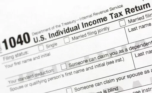 A portion of the 1040 U.S. Individual Income Tax Return form is shown July 24, 2018, in New York. The IRS said Tuesday, June 21, 2022, that it will have erased its backlog of last season's tax returns by the end of this week. (AP Photo/Mark Lennihan, File)