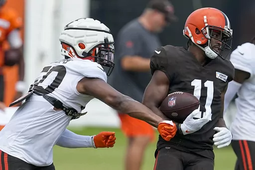 Cleveland Browns' Jacob Phillips knocks the ball away from Donovan Peoples-Jones during drills at the NFL football team's training camp on Saturday, July 29, 2023, in White Sulphur Springs, W.Va. (AP Photo/Chris Carlson)
