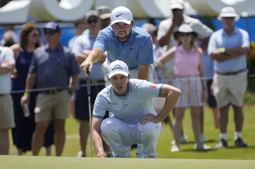 Matt Fitzpatrick lines up a shot with his brother Alex Fitzpatrick, above, both of England, on the ninth green during the first round of the PGA Zurich Classic golf tournament at TPC Louisiana in Avondale, La., Thursday, April 20, 2023. (AP Photo/Gerald Herbert)