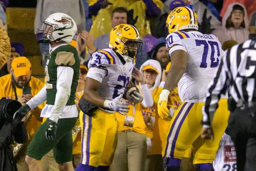 LSU running back Noah Cain (21) celebrates a touchdown against UAB during the first half of an NCAA college football game in Baton Rouge, La., Saturday, Nov. 19, 2022. (AP Photo/Matthew Hinton)