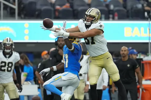 New Orleans Saints tight end Lucas Krull (87) pulls in a pass reception over Los Angeles Chargers safety Raheem Layne (41) in the first half of an NFL football game in Inglewood, Calif., Sunday, Aug. 20, 2023. (AP Photo/Marcio Jose Sanchez)