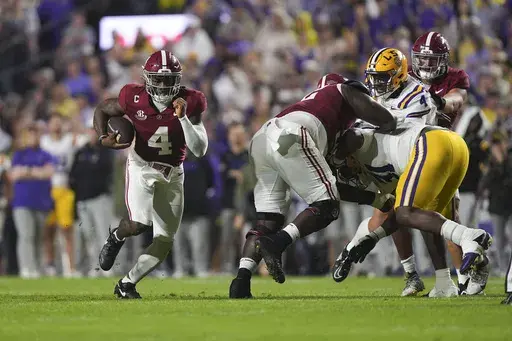 Alabama quarterback Jalen Milroe (4) carries on a long touchdown carry in the first half an NCAA college football game against LSU in Baton Rouge, La., Saturday, Nov. 9, 2024. (AP Photo/Gerald Herbert)