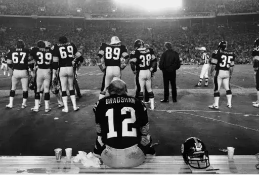 Pittsburgh Steelers quarterback Terry Bradshaw sits on the bench as the rest of his team watches the closing minutes of the XIII Super Bowl, in Miami, Fla, on Jan, 21, 1979. (AP Photp/Harry Cabluck, File)
