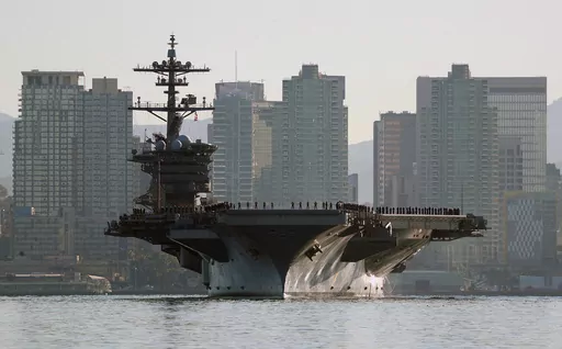 Sailors and marines line the deck of the aircraft carrier USS Abraham Lincoln (CVN-72) as it deploys from San Diego on Jan. 3, 2022. Two of the most populous states and two of the largest cities in the U.S. filed requests for corrections to their 2020 census figures at the end of last month. The slip-up, so to speak, reportedly took place on the aircraft carrier USS Abraham Lincoln. California officials believe its more than 5,000 crew members were wrongly assigned to San Diego's population tota