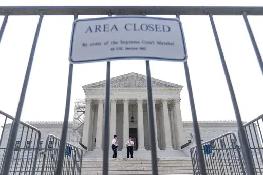 Security works on the steps of the Supreme Court, Friday, June 30, 2023, as decisions are expected in Washington. A year after its sweeping gun rights ruling, the Supreme Court has agreed to decide whether judges are going too far in striking down restrictions on firearms. The justices said Friday they will hear the Biden administration’s appeal of one such ruling that struck down as unconstitutional a federal law meant to keep guns away from people who have domestic violence restraining order