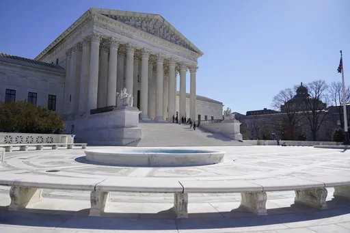 People stand on the steps of the U.S. Supreme Court, Feb.11, 2022, in Washington. The Supreme Court has agreed to take up a dispute over a medication used in the most common method of abortion in the United States. It’s the court’s first abortion case since it overturned Roe v. Wade last year. (AP Photo/Mariam Zuhaib, File)