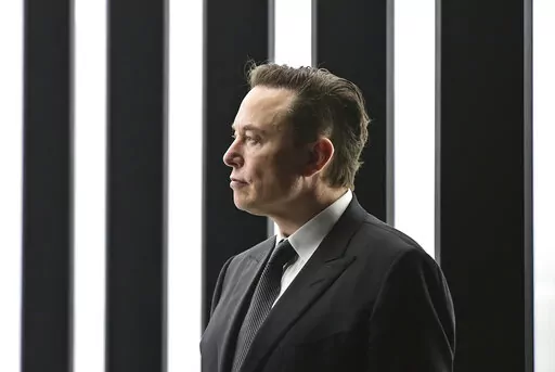 Elon Musk, Tesla CEO, attends the opening of the Tesla factory Berlin Brandenburg in Gruenheide, Germany, March 22, 2022. Musk, the world's richest man and the owner of SpaceX and Tesla, says he is a free speech absolutist who doesn't support the kind of content moderation that saw people like ex-President Donald Trump get banned for inciting violence (Patrick Pleul/Pool via AP, File)