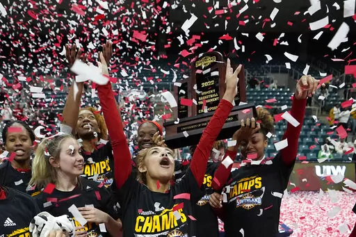 Incarnate Word's Destiny Jenkins, center, celebrates with teammates after the Southland Conference tournament championship NCAA college basketball game against Southeastern Louisiana Sunday, March 13, 2022, in Katy, Texas. Incarnate Word won 56-52 in overtime. (AP Photo/David J. Phillip)