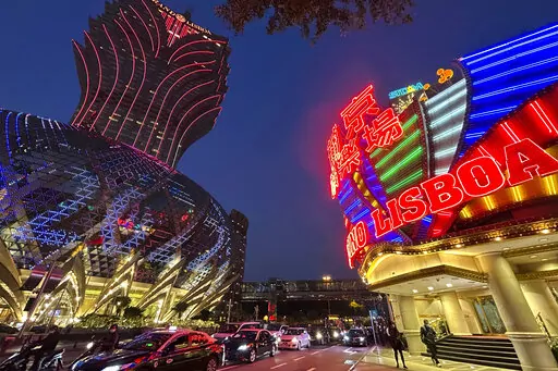 Casino Lisboa, right, is seen in Macao on Dec. 28, 2022. Gambling haven Macao’s relaxation of border restrictions after China rolled back its "zero-COVID" strategy is widely expected to boost its tourism-driven economy. The gaming hub on China's south coast near Hong Kong has endured some of the world’s strictest anti-virus controls for nearly three years. Now, China's worst wave of infections so far is keeping away the hoards of high rollers who usually fill its casinos. (AP Photo/Kanis Leu