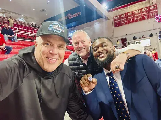 This photo provided by Chuck Everson shows 1985 national champion Villanova Wildcats Chuck Everson, left, and Brian Harrington, middle, return a lost 2016 national championship ring to Kris Jenkins on Nov. 9, 2024 at Carnesecca Arena on the campus of St Johns in New York. (Chuck Everson via AP)