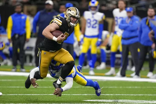 New Orleans Saints tight end Taysom Hill (7) tries to get past Los Angeles Rams cornerback Jalen Ramsey in the first half of an NFL football game in New Orleans, Sunday, Nov. 20, 2022. (AP Photo/Gerald Herbert)