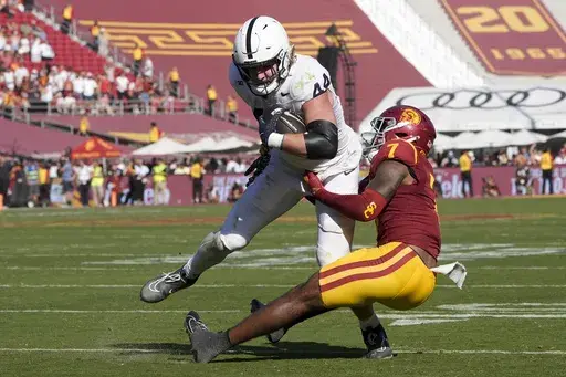 Penn State tight end Tyler Warren (44) makes a catch while being tackled by Southern California safety Kamari Ramsey (7) during second half of an NCAA college football game Saturday, Oct. 12, 2024, in Los Angeles. (AP Photo/Marcio Jose Sanchez)