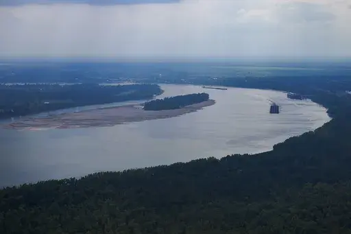 In this aerial photo a tugboat pushing barges navigates around sandbars amid low water levels on the Mississippi River in Livingston Parish, La., Sept. 14, 2023. (AP Photo/Gerald Herbert, File)