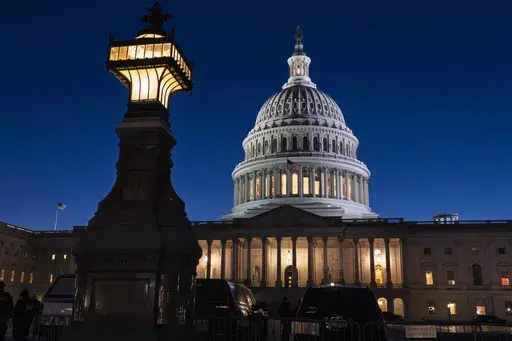 The U.S. Capitol is illuminated at dusk before President Donald Trump's address to a joint session of Congress, in Washington, Tuesday, March 4, 2025. (AP Photo/J. Scott Applewhite)
