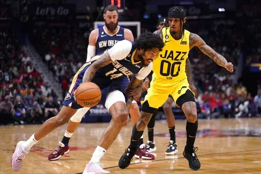 New Orleans Pelicans forward Brandon Ingram (14) drives to the basket against Utah Jazz guard Jordan Clarkson (00) in the first half of an NBA basketball game in New Orleans, Sunday, Oct. 23, 2022. (AP Photo/Gerald Herbert)